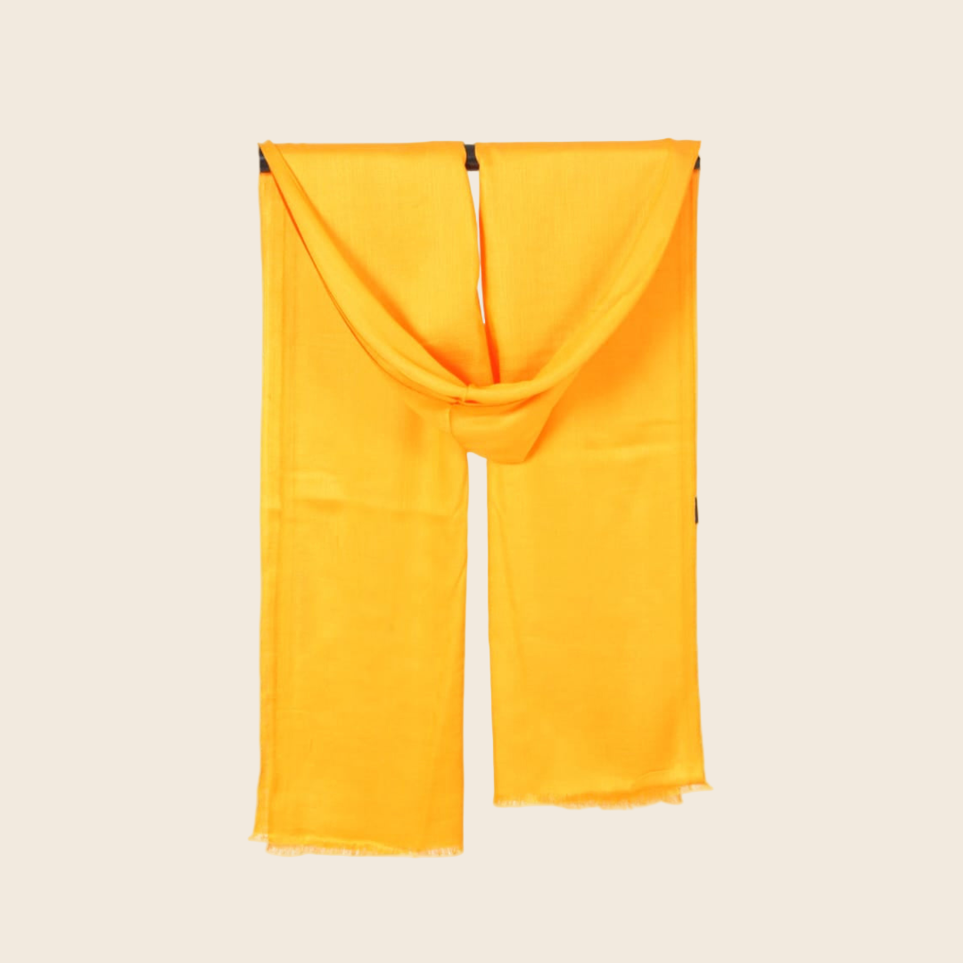Yellow scarf draped over a beige background