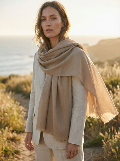 Khaki Tagelmust styled as a lightweight travel scarf for women, Touareg inspired Moroccan shawl for desert sun protection.
