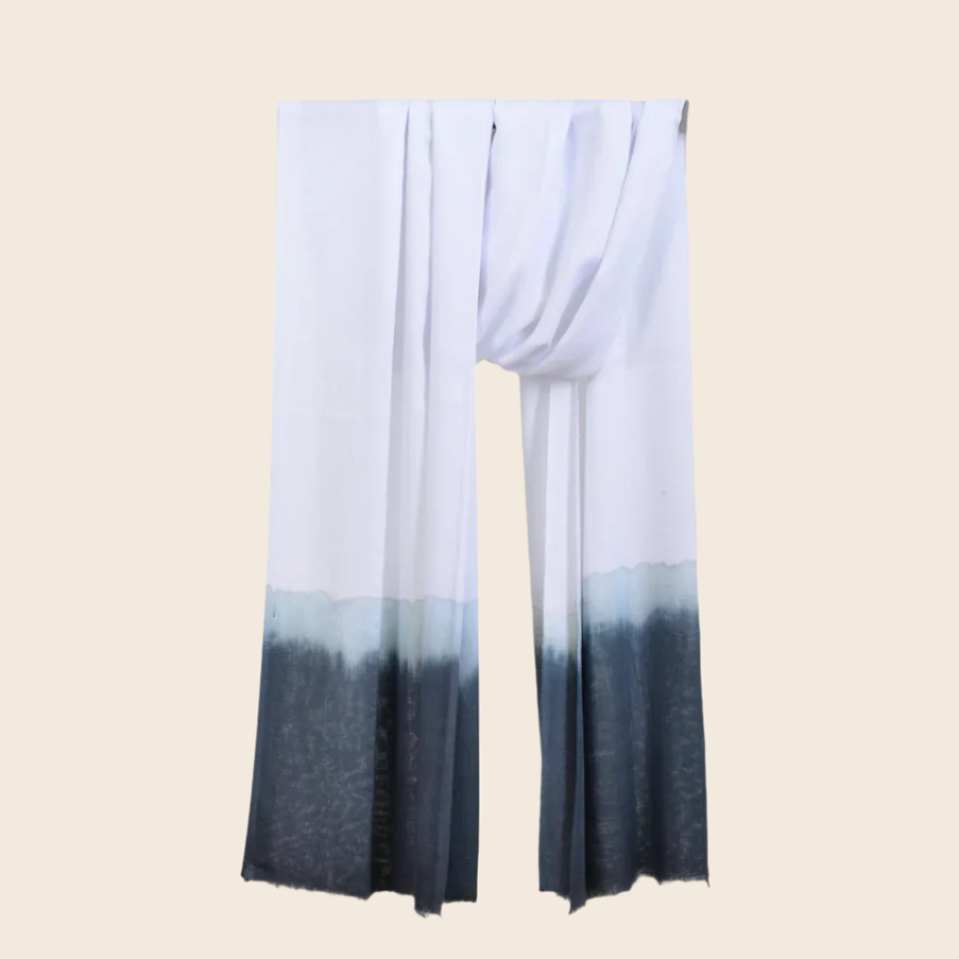 Ghost White Soaked Tagelmust scarf – crisp white hanging wrap fading through ice‑blue to charcoal grey gradient. Sustainably sourced lightweight Moroccan headscarf ideal for nomadic travelers searching for white, blue, or grey scarves for hot‑weather, dry‑climate adventures.