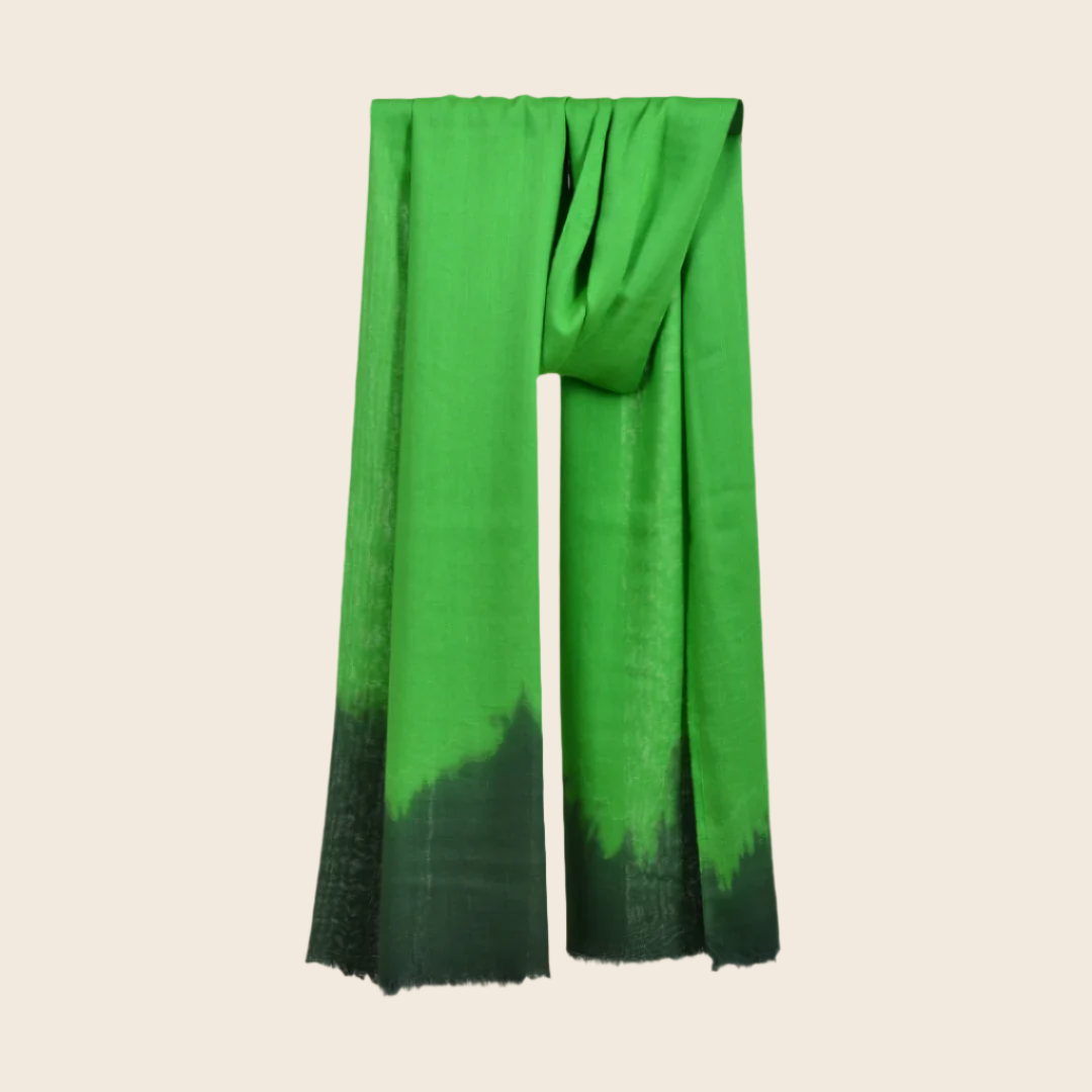 Keppel Green Soaked Tagelmust scarf – bold emerald green hanging wrap fading to deep forest black gradient. Sustainably sourced lightweight Moroccan headscarf ideal for nomadic travelers searching for emerald or dark‑green scarves for hot‑weather, dry‑climate adventures.